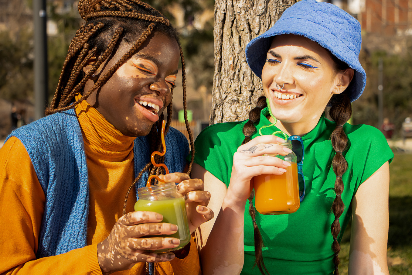 Two Female Friends with Vitiligo Drinking Juice
